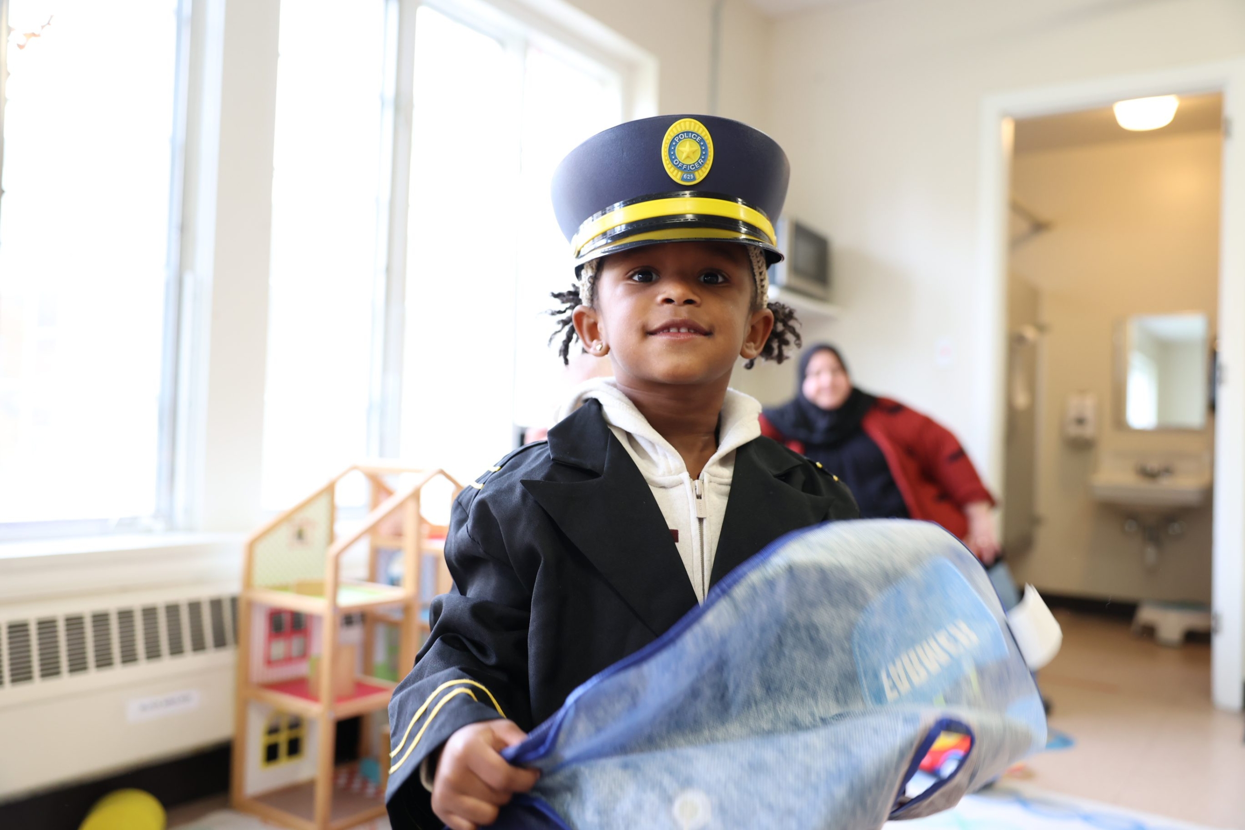 Kid wearing a police hat