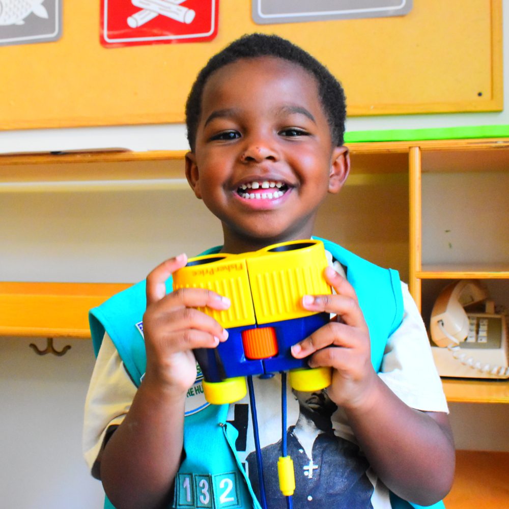 Kid smiling at Day One Project workshop